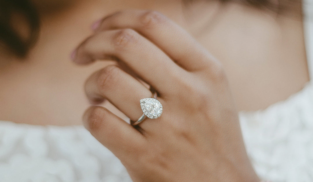 pear shaped diamond ring on brides hand